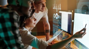 People looking at software in a futuristic setting.
