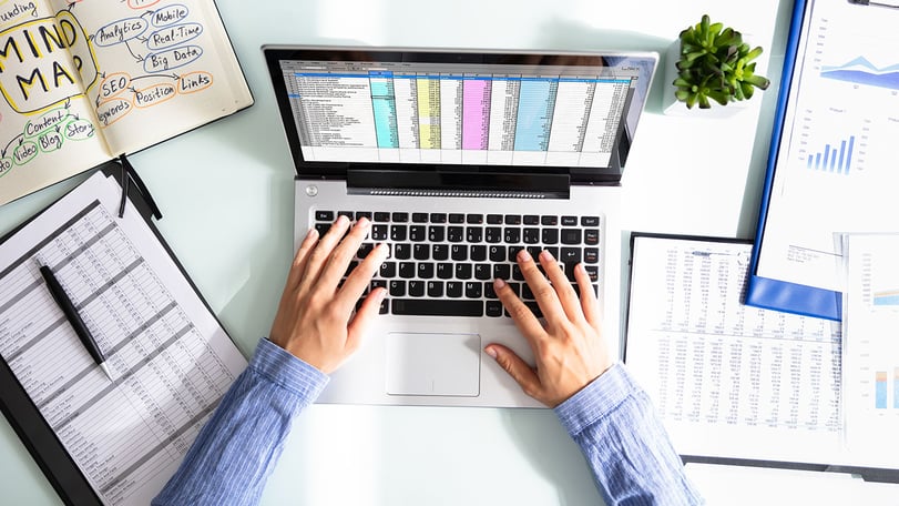 Businesswoman analyzing data on laptop