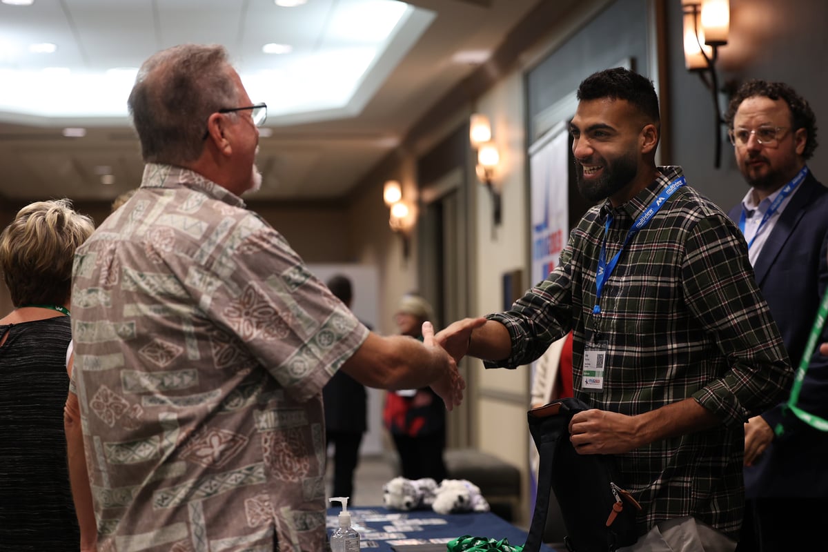 Multiview Client Success Executive (CSE) Alaa greeting a guest during IMUG 2023