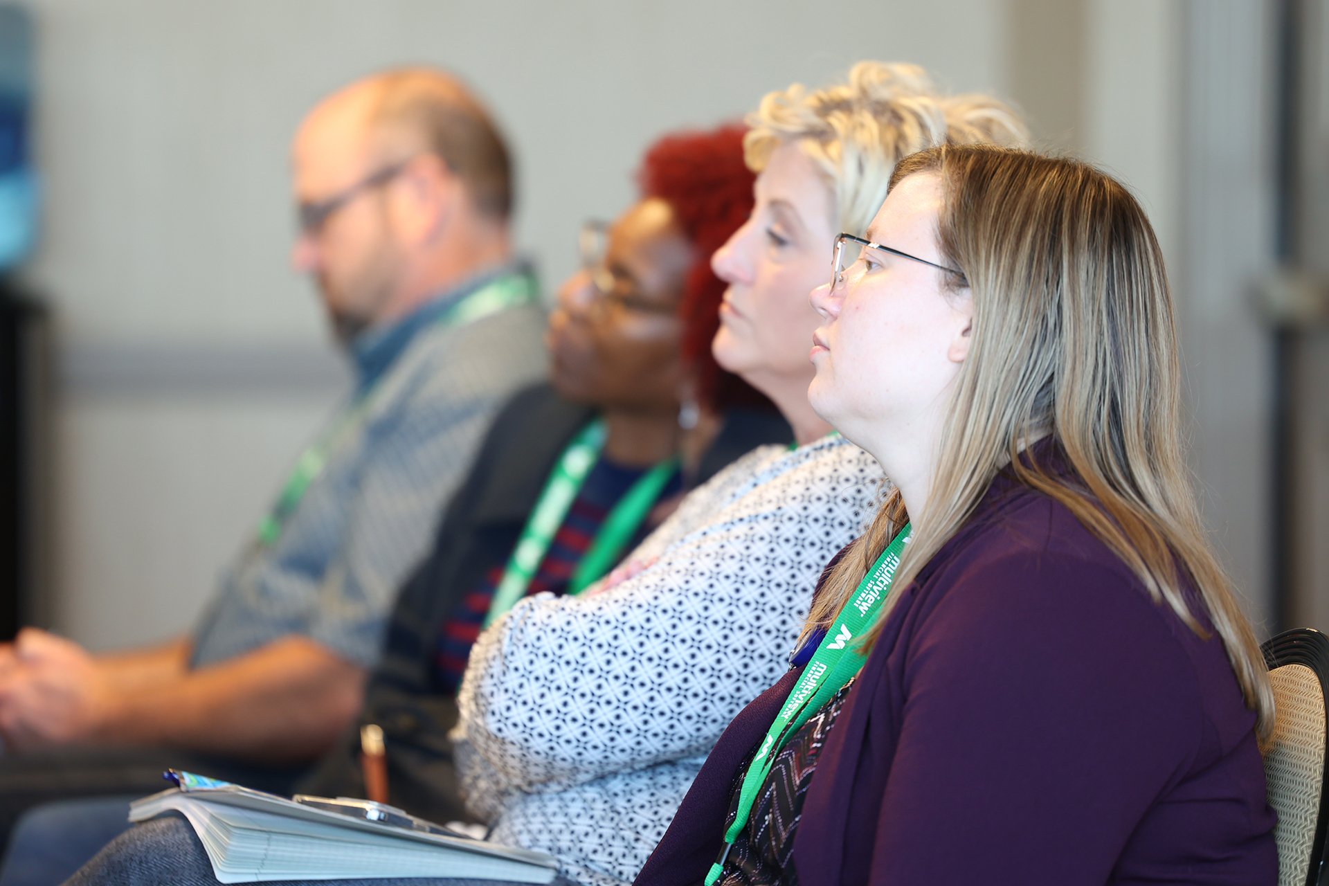 Clients listening intently during a session at IMUG 2023
