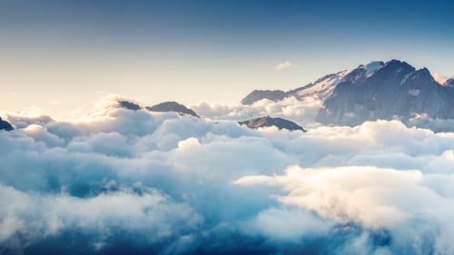 Mountain appearing above clouds.