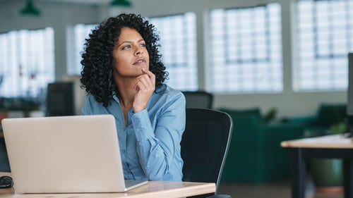 Businesswoman considering different software choices.