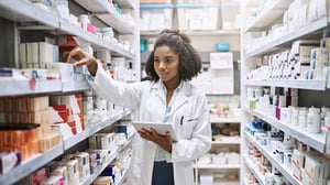 Young pharmacist organizing stock.