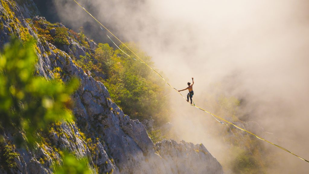 Man on tightrope over canyon