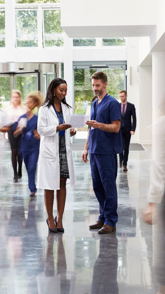 Staff in busy lobby of a modern hospital